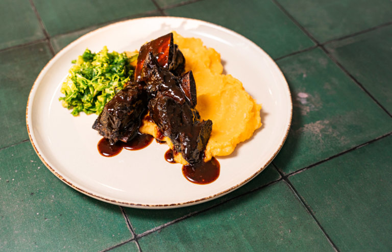 Sticky Date & Pomegranate Short Ribs with Root Vegetable Mash and Greens - Image by Yaffa Judah